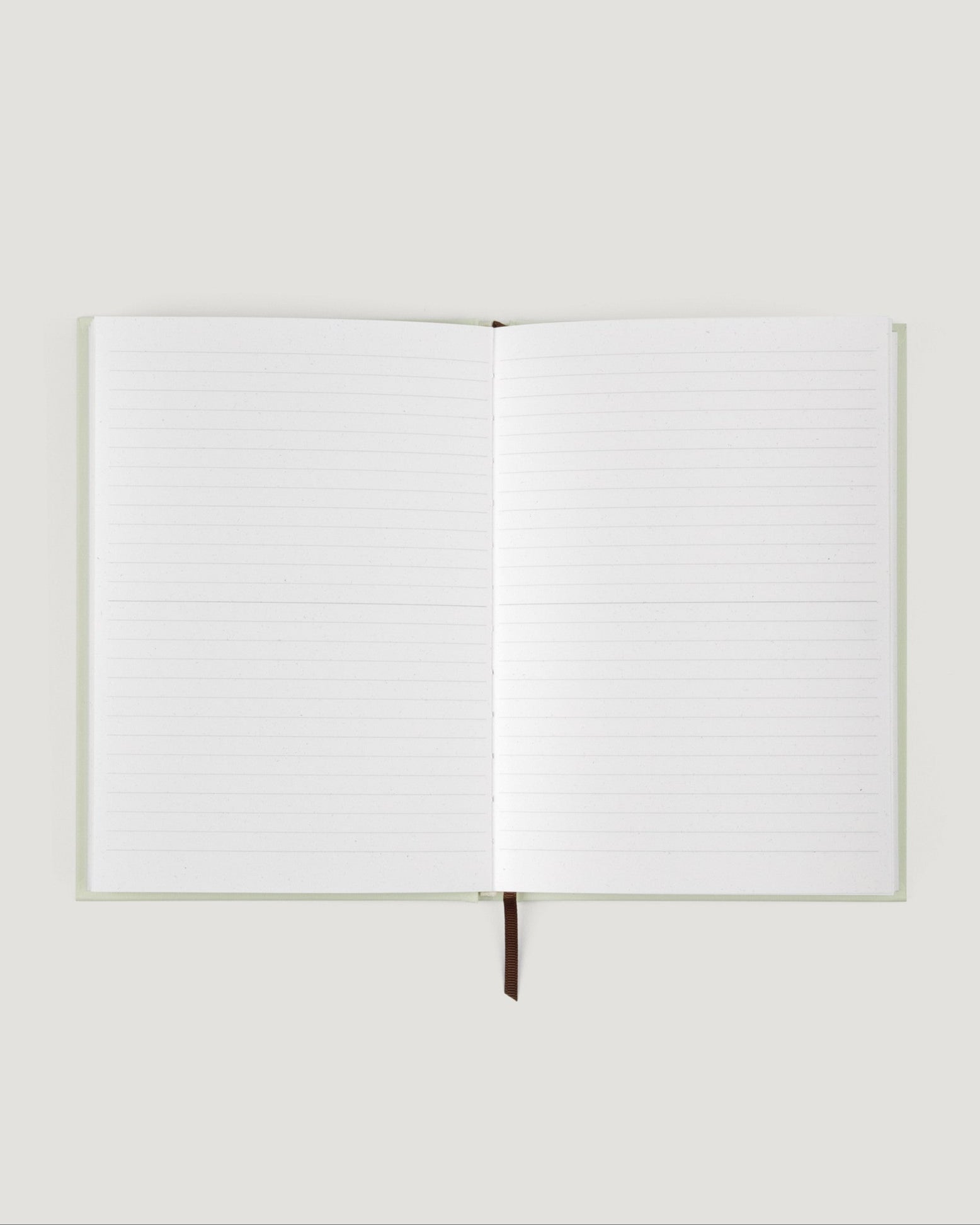 Open notebook with blank pages on a white background