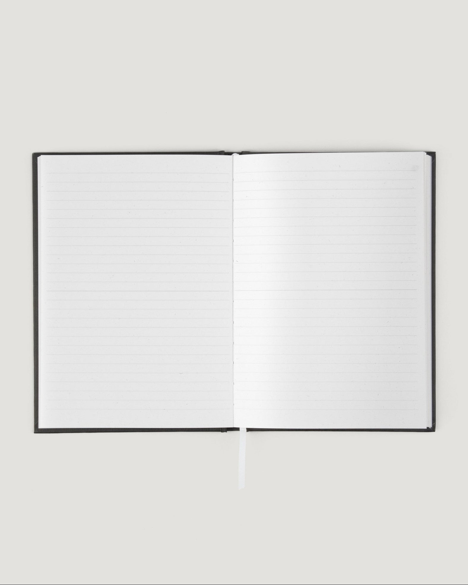 Open notebook with blank pages on a light gray background