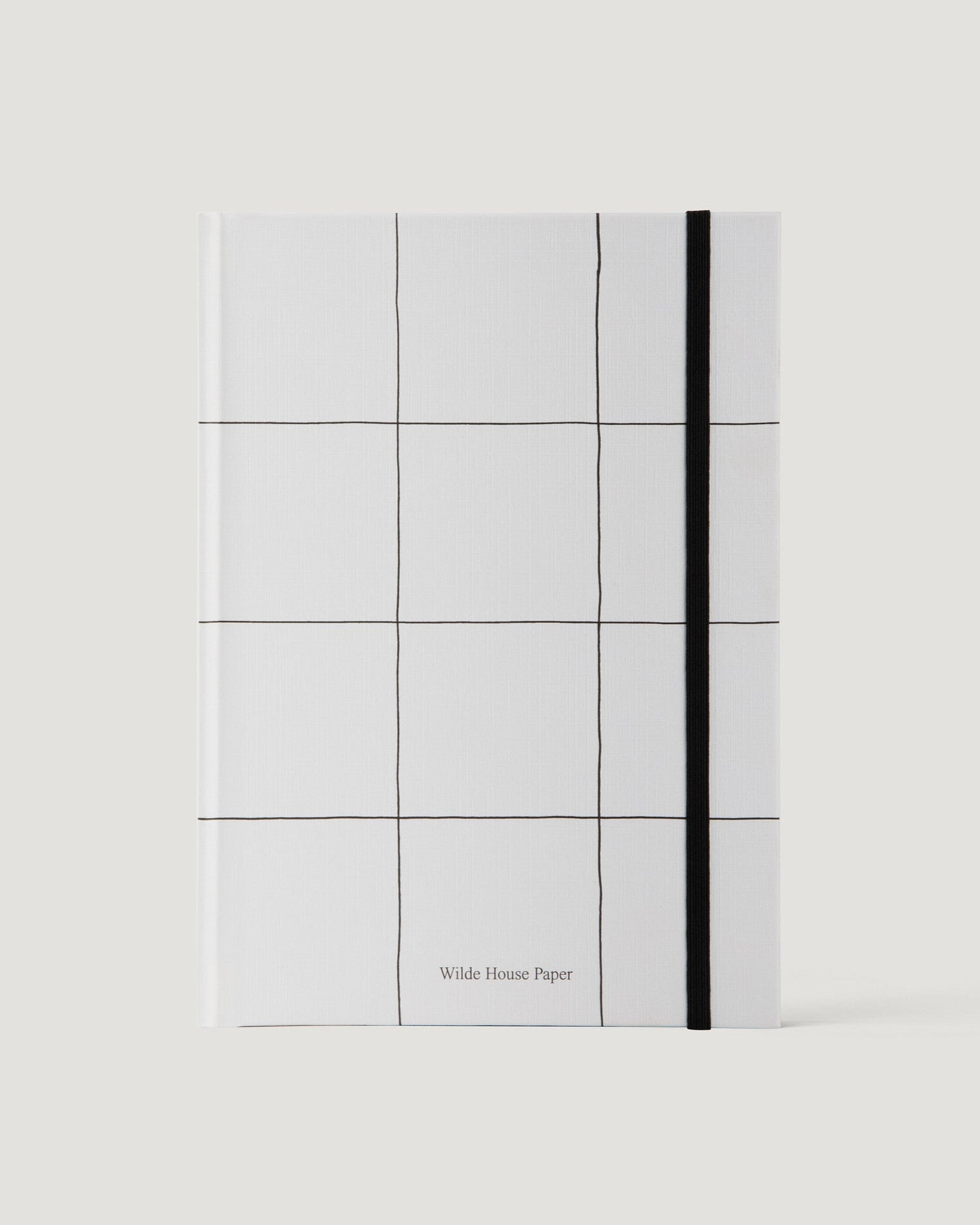 White notebook with grid pattern and black line on a white background