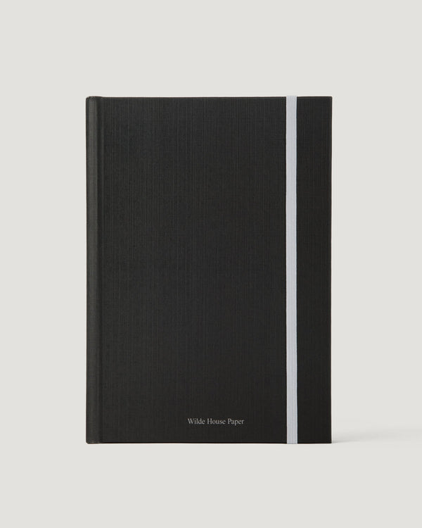 Black notebook with a white stripe on a light gray background